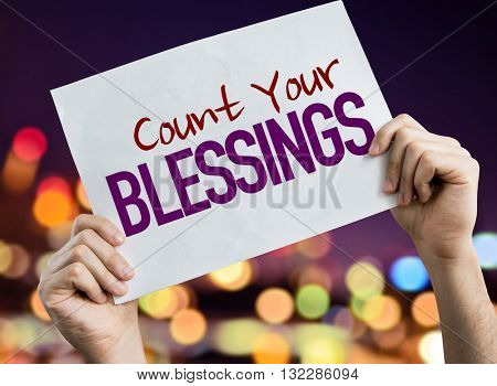 Count Your Blessings placard with night lights on background