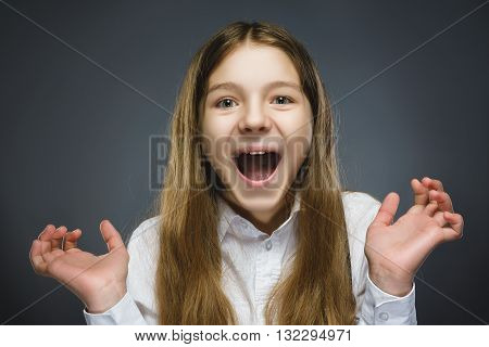 Closeup Portrait of happy girl going surprise isolated on gray background.