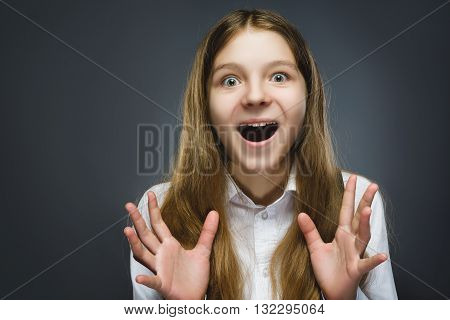 Closeup Portrait of happy girl going surprise isolated on gray background.