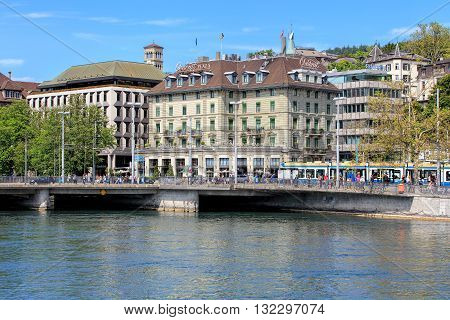 Zurich, Switzerland - 25 May, 2016: people on Bahnhofbruecke bridge over the Limmat river, Central square, Hotel Central Plaza building. Zurich is the largest city in Switzerland and the capital of the Swiss canton of Zurich.