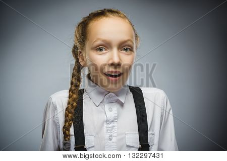 Closeup Portrait of happy girl going surprise isolated on gray background.