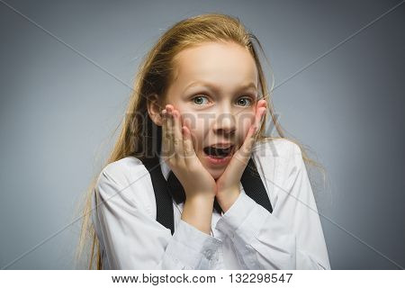 Closeup Portrait of happy girl going surprise isolated on gray background.