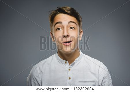 Closeup Portrait of happy boy going surprise isolated on gray background.