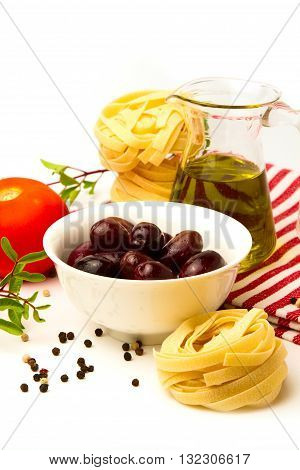 Italian pasta with olives olive oil and tomato on white background