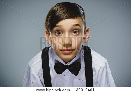 Closeup Portrait of happy boy going surprise isolated on gray background.