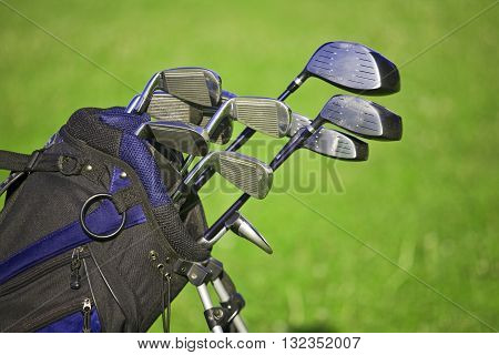 Golf clubs set in bag with golf field in background
