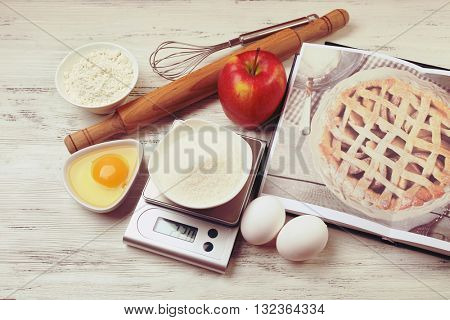 Sugar with digital kitchen scales on wooden table. Cooking apple cake concept