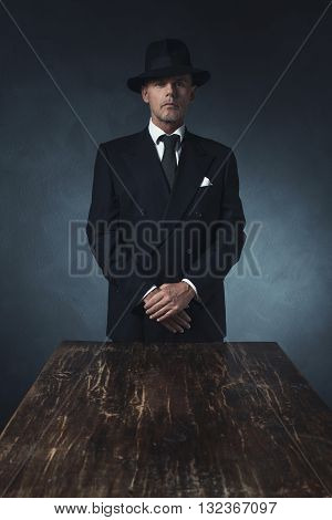 Bossy Vintage 1940 Businessman Standing Behind Wooden Table.