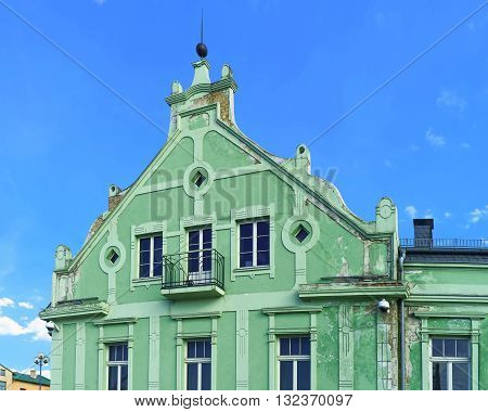 Green Building With A Balcony In Ventspils In Latvia