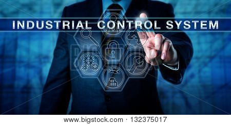 Manager is pushing INDUSTRIAL CONTROL SYSTEM on an interactive virtual touch screen. Industry metaphor and business and computing concept for embedded control of industrial processes.