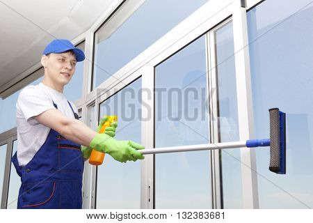 Professional cleaning, man washes window