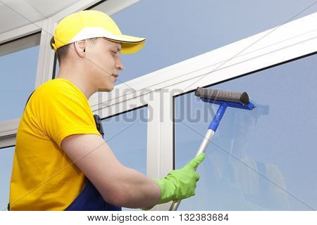 Professional cleaning, man washes window