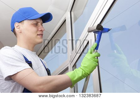 Professional cleaning, man washes window