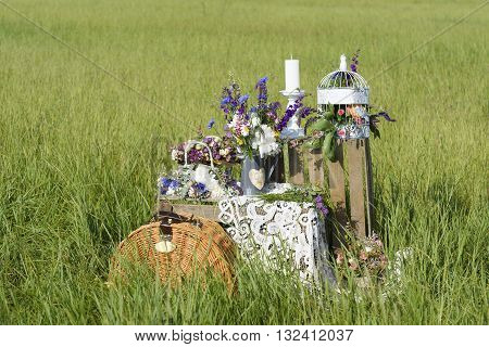 Beautiful flower composition in rustic style outdoors. Decorative scenery in summer.