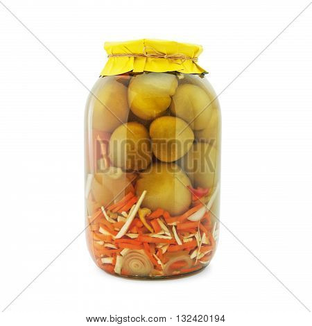 Homemade pickled green tomatoes with carrots, garlic, onions and horseradish in glass jar with yellow paper wrapper. Homemade preserves, pickles. Jar of canned marinated tomatoes isolated on white