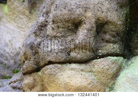 Stone altar carved in sandstone cliff - detail of the head of angel