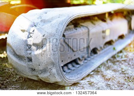 Bulldozer or earth mover with selective focus and copy space. Heavy machine on a construction site. Close-up or macro shot of a caterpillar track.