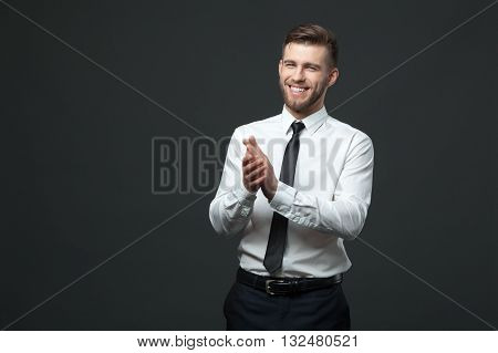 Studio Portrait Of Young Happy Handsome Businessman Claping Hands Isolated.