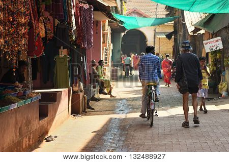 GOKARNA KARNATAKA INDIA - JANUARY 29 2016: Crowded narrow strett with outdoor shops in Gokarna city