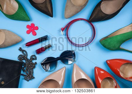 Women clothing set and accessories on light background.Top view different shoes on light background. Copy space for text.