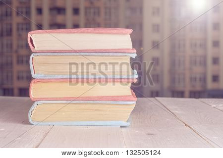 Books in the window with city view. Copy space for text.