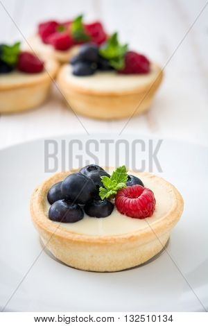 Delicious sweet tartlets with raspberries and blueberries