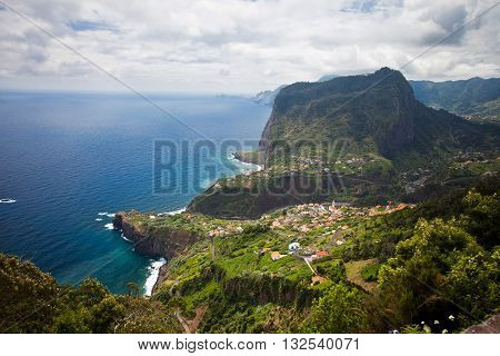 Coastal view in Madeira with settlement at the foot of the mountain