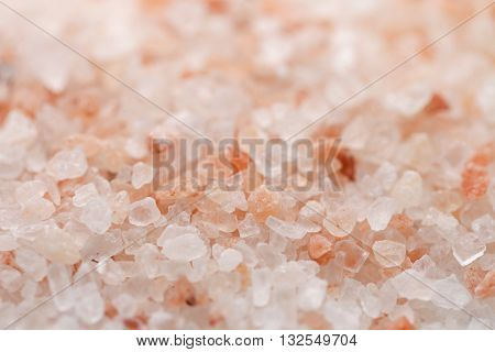 Himalaya pink salt background. Himalayan salt pile. Pink crystal salt. Close up Himalayan salt - pink and orange coarse crystals.