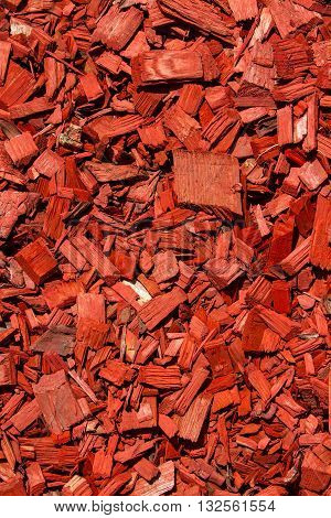 Sloping green lawn. Red lawn wood chips of different sizes