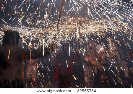 Traditional correfocs (fire runs) performance (Spanish: Baile de Diablos Catalan: Ball de Diables or Correfocs). Group of people dressed as devils and treading the streets letting off fireworks.