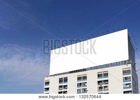 the white background billboard building on the apatment building with the sky