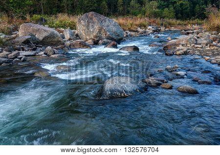 Beautiful Reshi River water flowing through stones and rocks at dawn Sikkim India. Reshi is one of the most famous rivers of Sikkim flowing through the state and serving water to many local people.