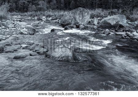 Beautiful Reshi River water flowing through rocksSikkim India. Reshi is one of the most famous rivers of Sikkim flowing through the state and serving water to many local people. Black & White image.