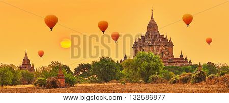 Balloons over Htilominlo Temple at sunrise in Bagan. Myanmar. Panorama