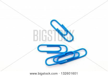 Blue paper clip isolated on white background
