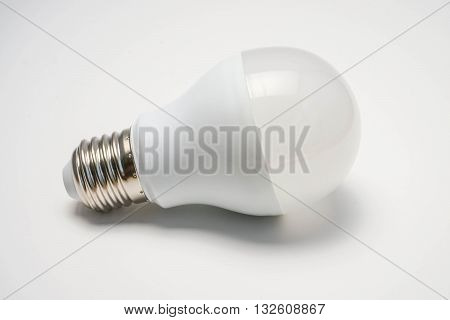 LED bulb in white background with light shadow