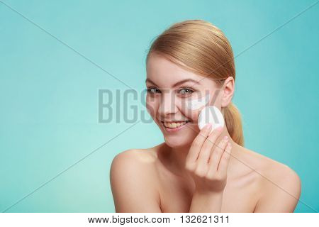 Woman Removing Makeup With Cream And Cotton Pad