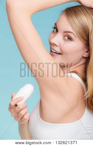 Girl Applying Stick Deodorant In Armpit.