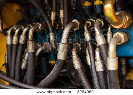 Industrial pipe system of hydraulic valves in an excavator