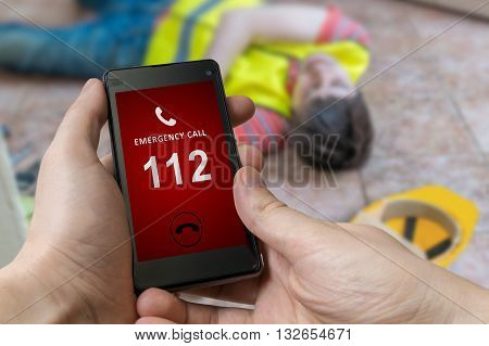 Man Dialing Emergency (112 Number) On Smartphone. Injured Worker