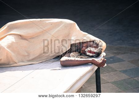 Jaipur India - 2014 December 29 : An Indian holy man sleeping inside a Hindu temple on Choti Chaupar square in the city of Jaipur also known as the Pink City in Rajasthan India