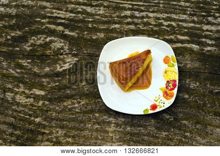 Flan - delicious creme dessert with caramel sauce.French creme caramel dessert or flan with strawberry and mint on the wooden background