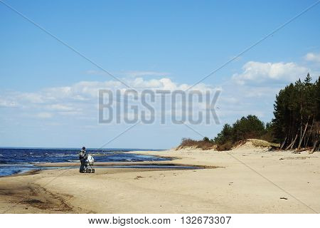 Baltic sea cost. Walking man with carrage