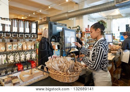 NEW YORK - CIRCA MARCH, 2016: worker at food store in Brooklyn. Brooklyn is the most populous of New York City's five boroughs.