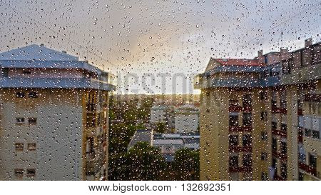 The rain in the city. Image captured through the window.