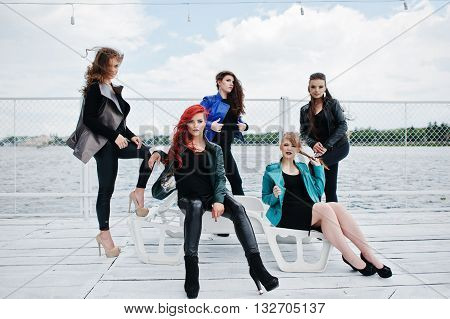 Five Beautiful Young Girls Models At Leather Jackets Posing On Berth.