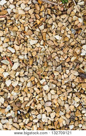 Vertical background of pea gravel scattered in neutral colors