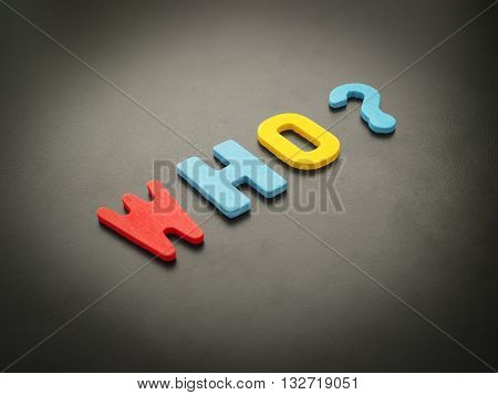 "Who" word from wood. Colorful of wooden Who question mark on black background.