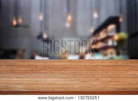 Top wooden table with blurred cafe background, stock photo