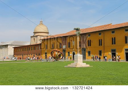 Pisa Italy - June 29 2015: Tourists walking on Piazza dei Miracoli in historic centre. Province Pisa Tuscany region of Italy
